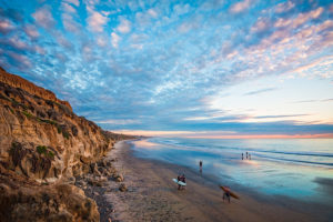Carlsbad Beach with pink and blue clouds and sandy beach