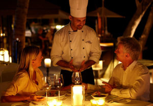 couple talking to chef at a romantic dinner