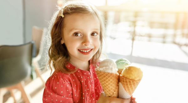 Young girl holding ice cream cones