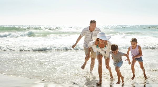 family laughing on the beach