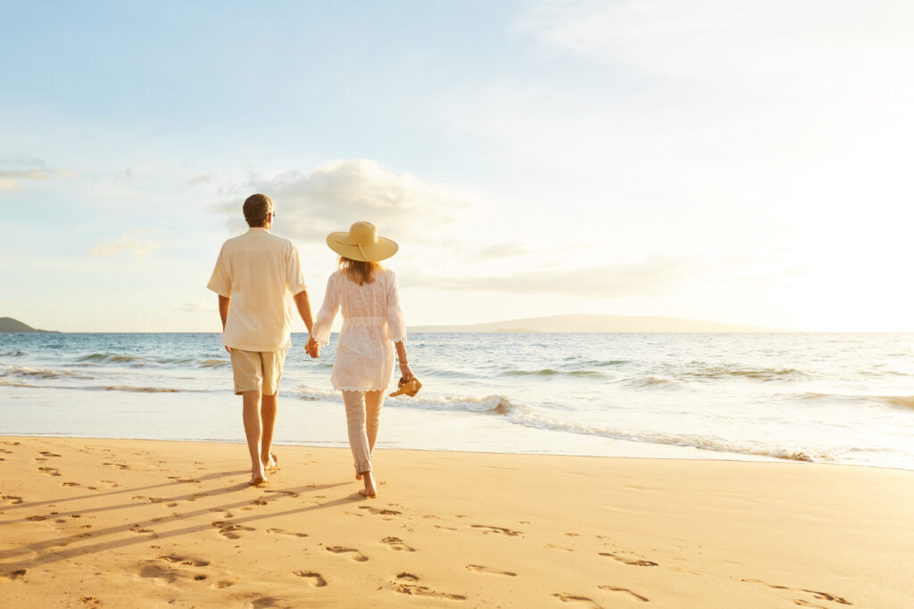 Couple Walking on the Beach at Sunset